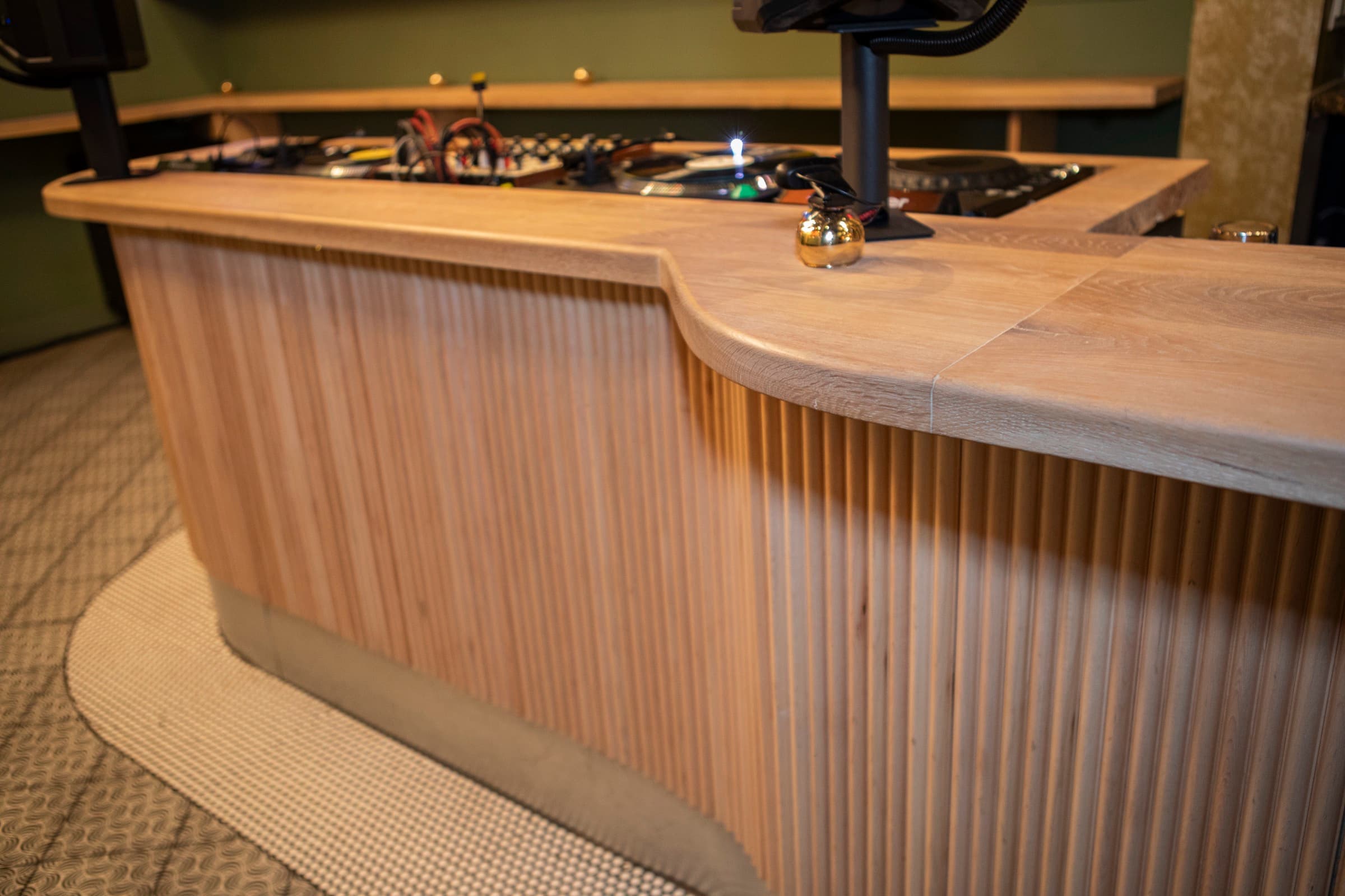 Boogie — curved slatted wood bar corner detail showing custom joinery